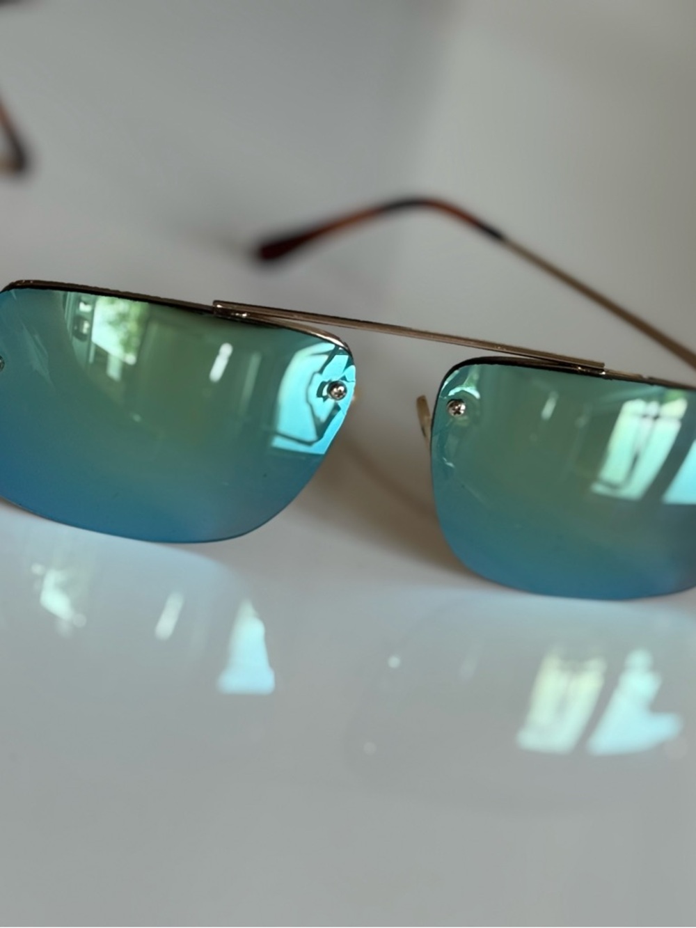 Izod Rimless Sunglasses with Blue-Green Mirrored Lenses